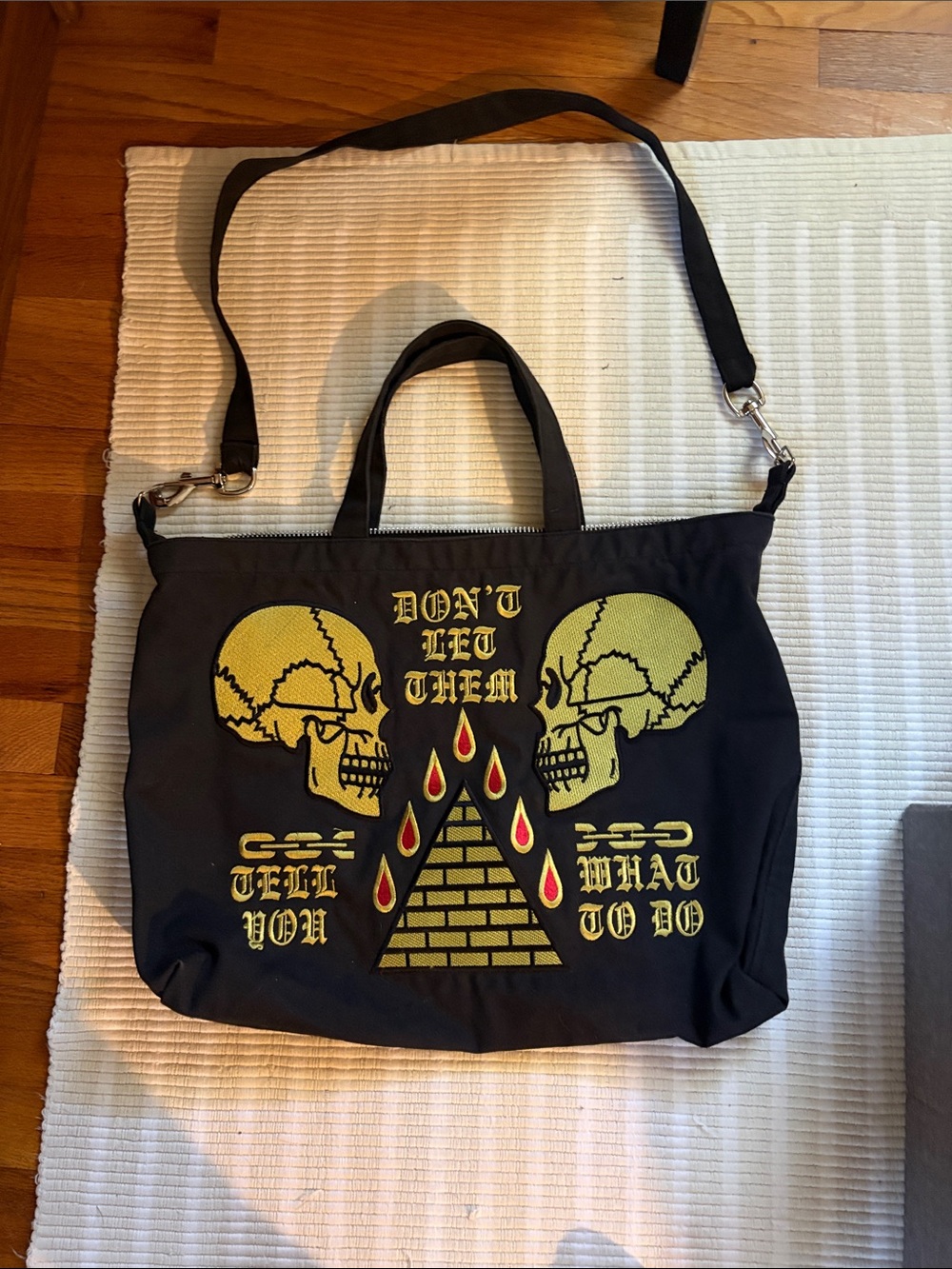 Black Graphic Skull Pyramid Tote Bag with Red Accents